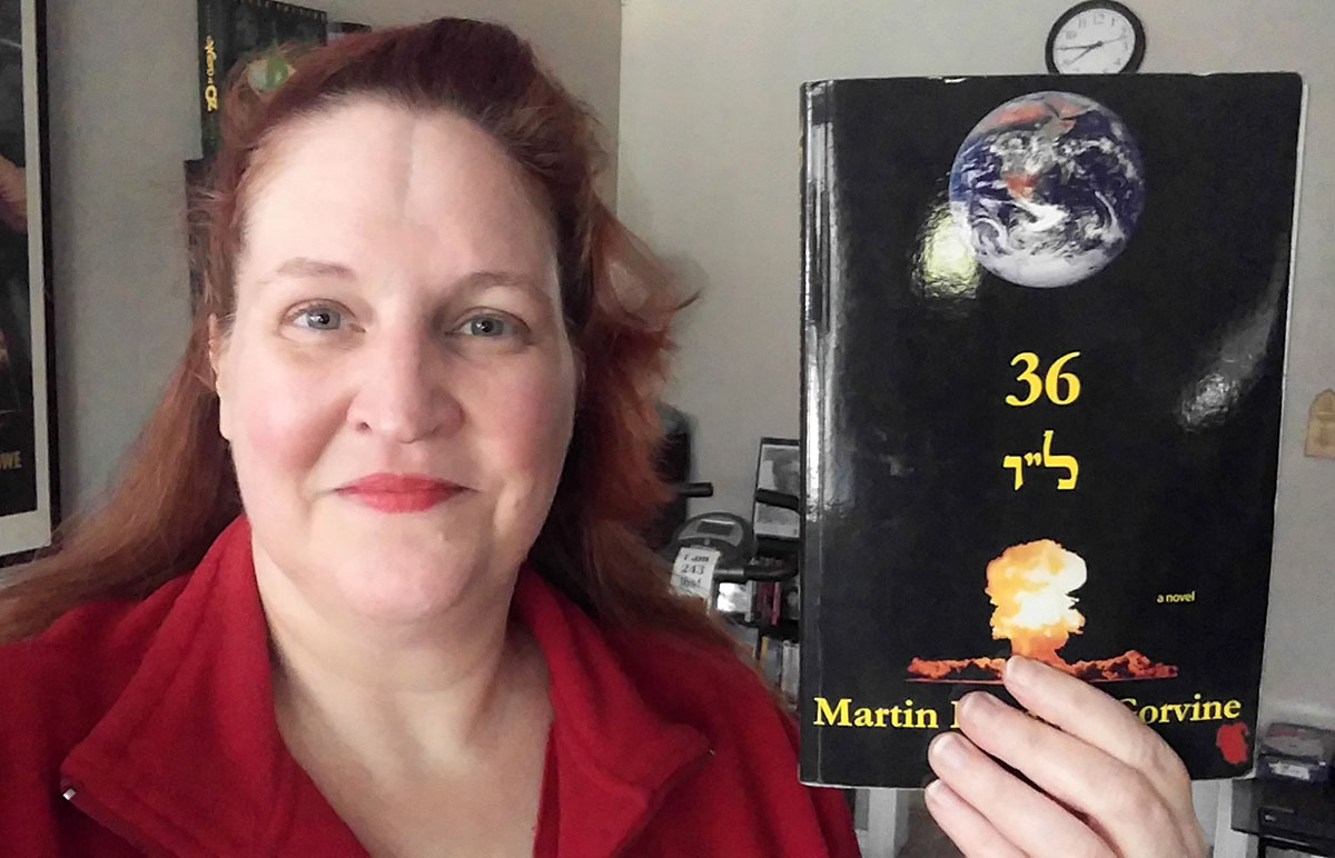 Carma holding a copy of “36” by Martin Berman-Gorvine